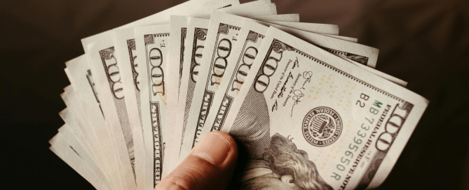 Person holding thousands of dollars in HVAC savings